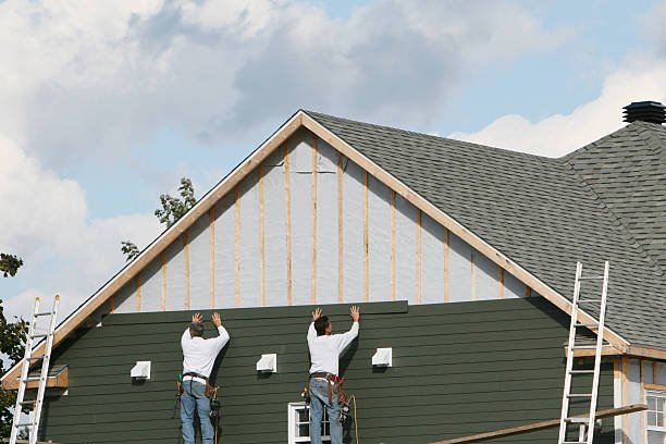 Professional Siding technician working in Elkton, FL